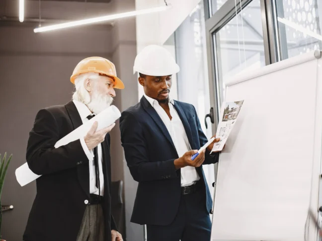 african-man-black-suit-old-engineer-with-boss-young-guy-with-senior-man-writing-board